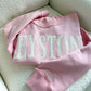 Pink sweatshirt with 'Keystone' text on a light background